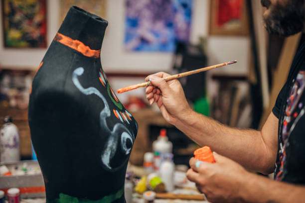 istock Man is painting in art studio 1189212858