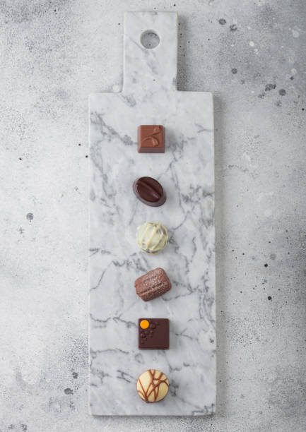 istock Luxury Chocolate candies selection on light marbel board. White, dark and milk chocolate assortment. 1189220287