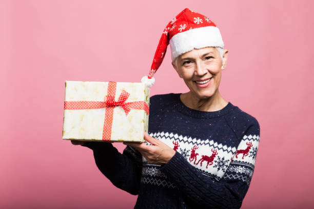 istock Satisfied woman holding a present 1189221723