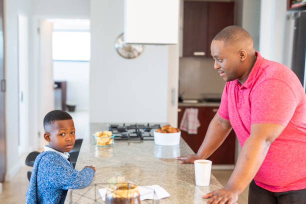 istock Boy and Father Having a Serious Talk in the Kitchen 1189223566