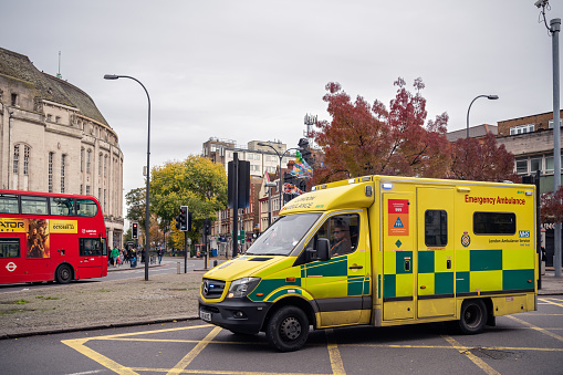 London, United Kingdom -  October 2019 : Emergency Ambulance speeds along a street in Catford, Lewisham borough, in response to an emergency call