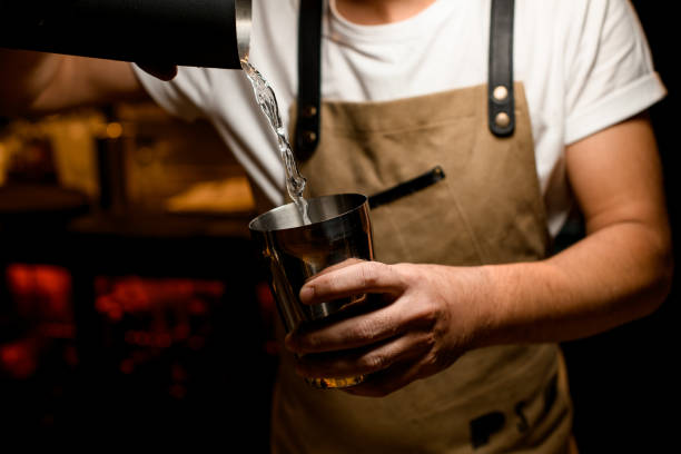 istock Bartender prepares alcohol cocktail with a shaker 1189225888