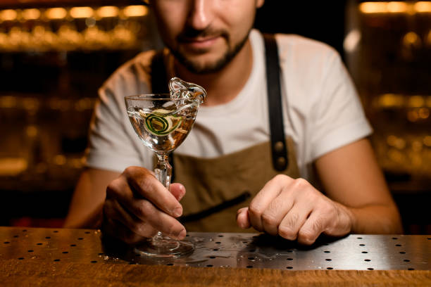 istock Splashing alcohol cocktail with lime zest on counter 1189226956
