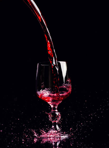 istock Red wine pouring into wine glass 1189227773
