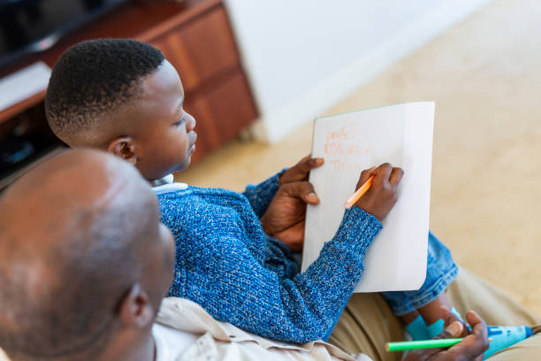 istock Schoolboy and Grandfather Doing Homework 1189229183
