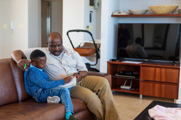 istock Schoolboy and Grandfather Doing Homework 1189229223