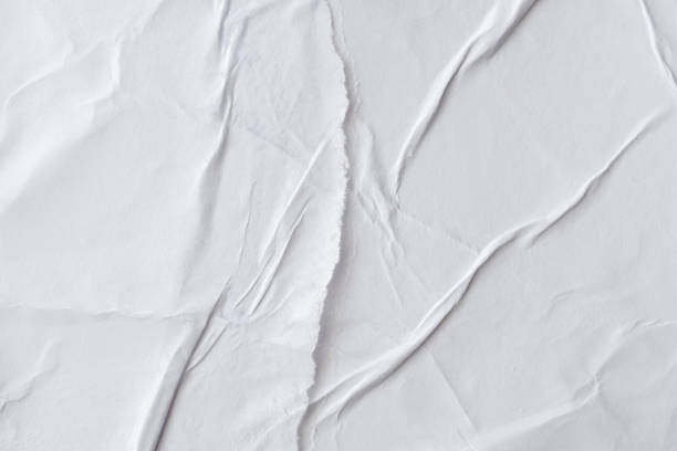 istock Blank white crumpled and creased paper poster texture background 1189231102