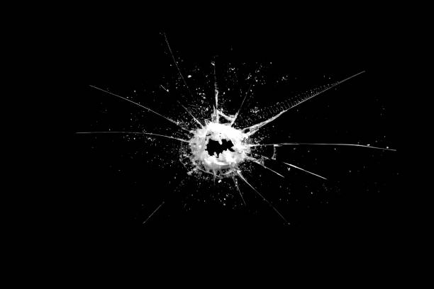 istock hole in the glass with cracks isolated on a black background 1189231131