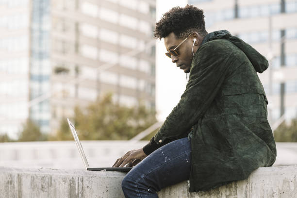 istock student working on laptop outdoors in the city 1189231208