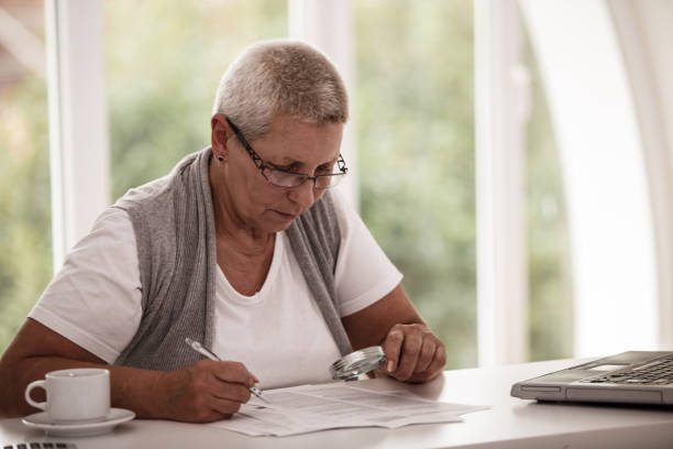 istock Senior woman concentrating while reading important documents 1189231227