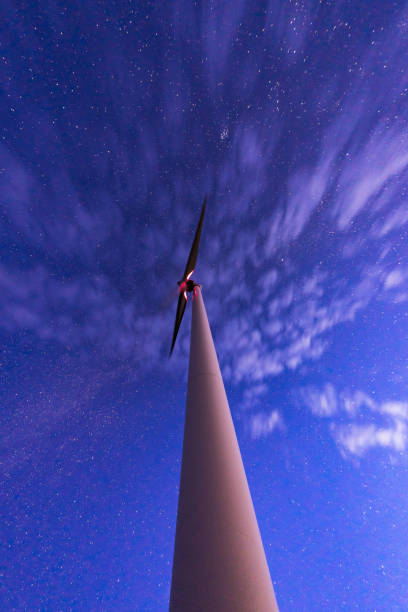istock wind power station and stars in sky 1189245570