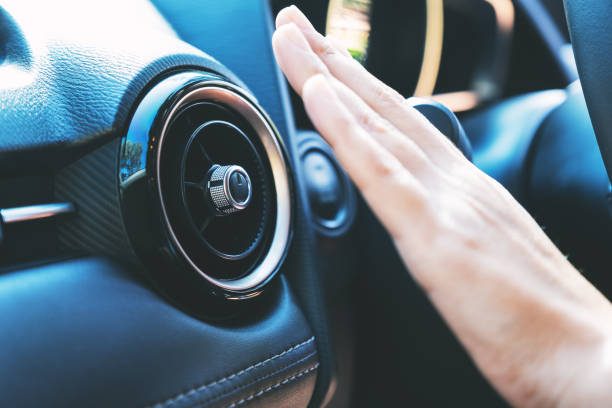 a hand checking the air conditioner system in the car - car air conditioner vehicle interior driving imagens e fotografias de stock