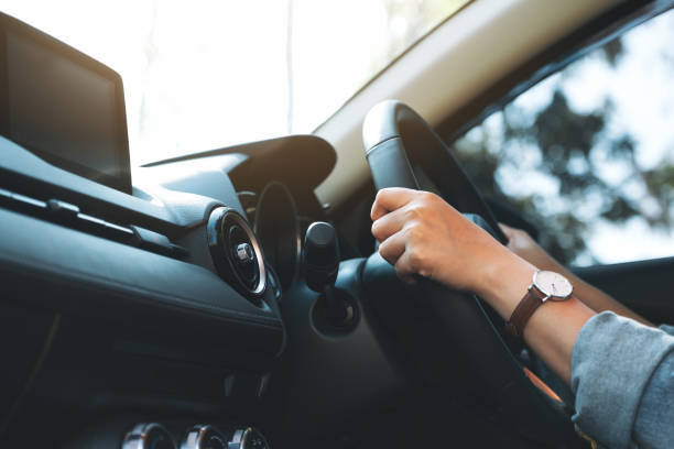 istock a woman holding steering wheel while driving a car 1189245760