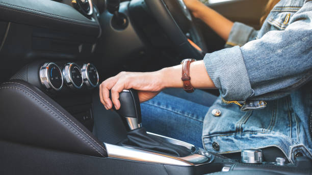 istock a female driver shifting automatic gear stick while driving car 1189245769