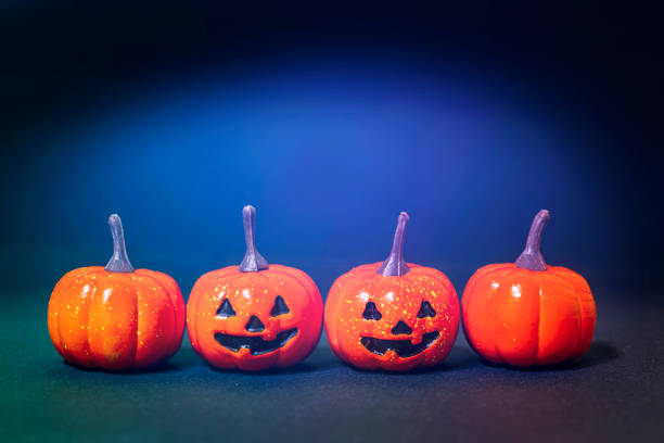 istock small smile pumpkins and common pumpkins in black with blue background. 1189247005