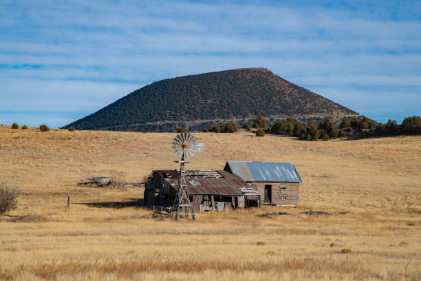 Old barn and windmill with volcano in background