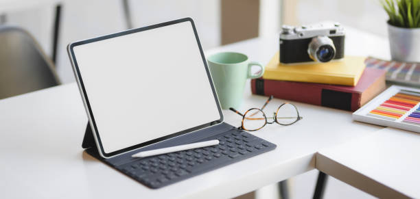 istock Close-up view of comfortable designer workspace with blank screen digital tablet and office supplies 1189260729