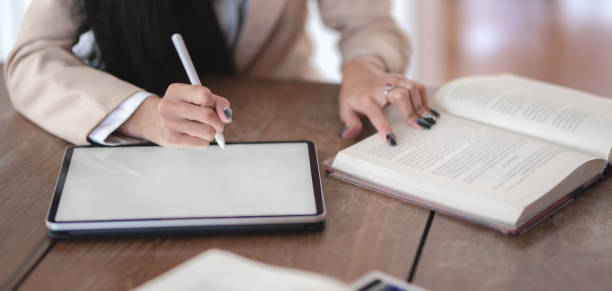 istock Close-up view of professional businesswoman working on her current project while using digital tablet 1189264318
