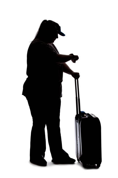 silhouette of a curvy woman waiting with luggage - waiting hourglass people impatient imagens e fotografias de stock