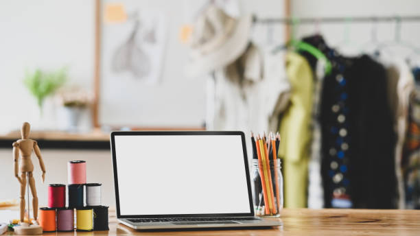 istock Workspace fashion designer with laptop computer, thread, pencil and dummy wood on desk. 1189265462