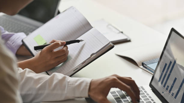 istock Cropped shot business meeting with finance data and writing notebook. 1189265549