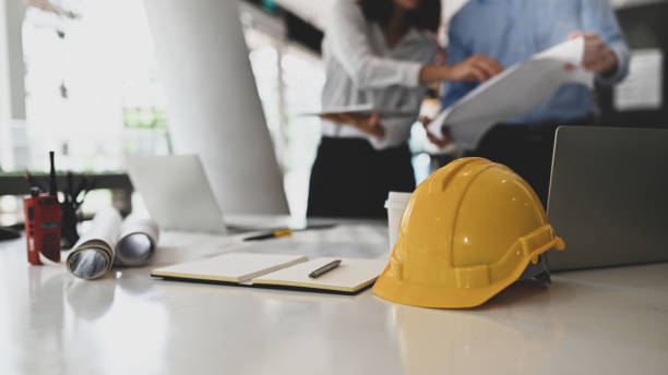 istock Architectural Office desk with architect meeting on blur background. 1189266189