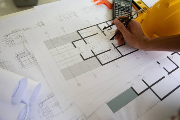 istock hand Engineers are writing home construction designs to bring them to prospective customers.concept 1189267386