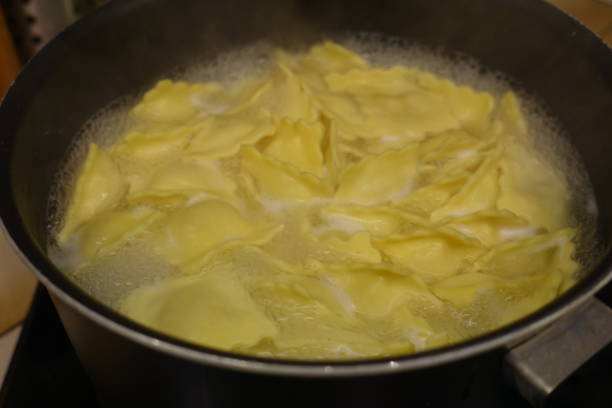 istock Stuffed ravioli with cheese being cooked in a saucepan 1189270592