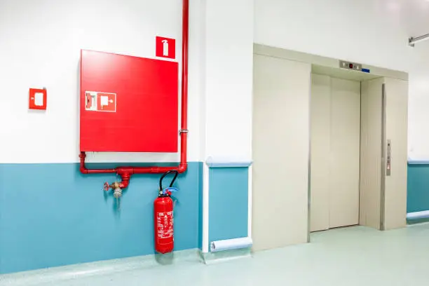 an fire hose hanging on the wall in an corrridor