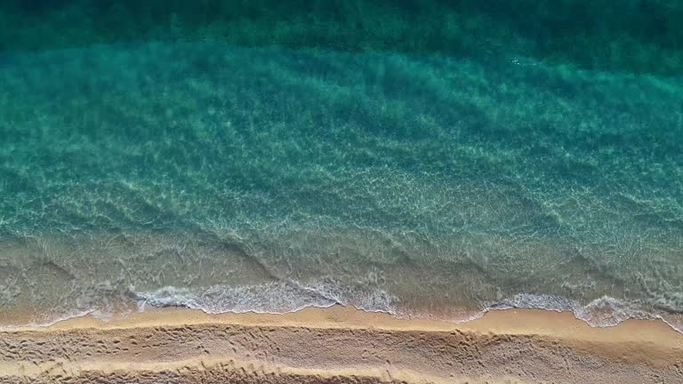 Aerial view of clear turquoise sea and waves