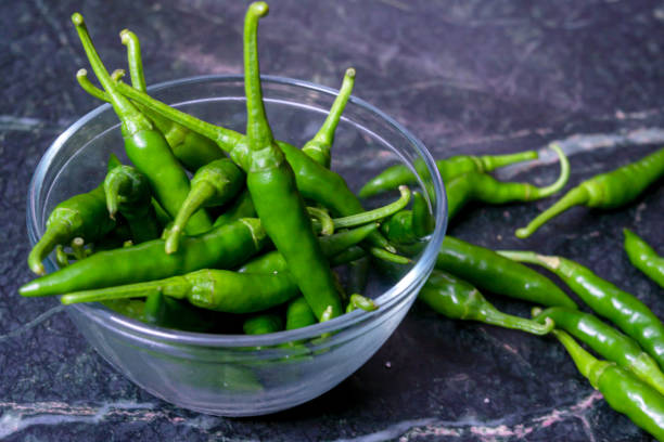 istock Fresh harvested green chili on texture background. 1189283039