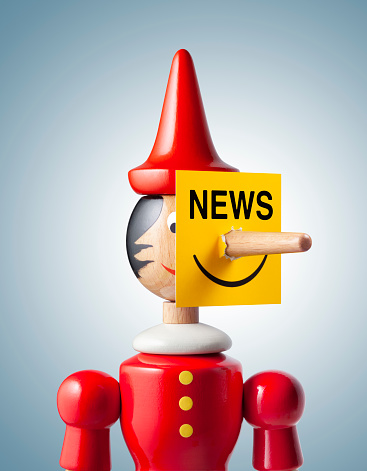 Fake News Pinocchio With Yellow Placard Hanging On The Nose Photo With  Clipping Path Stock Photo - Download Image Now - iStock