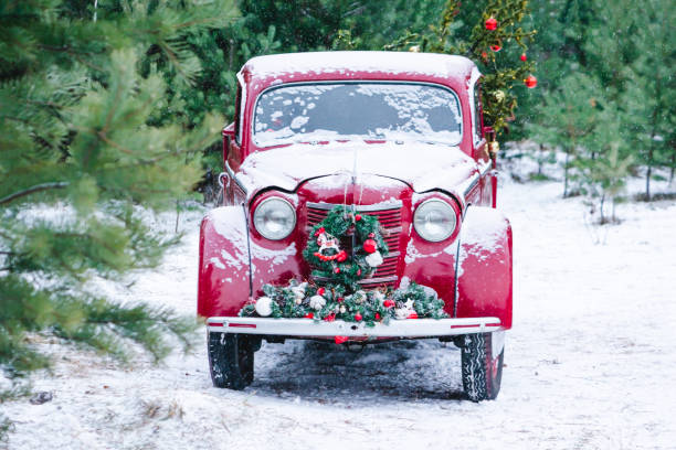 istock A red car with Christmas decorations and a Christmas tree is standing in a winter forest. Festive New Year concept. 1189285409