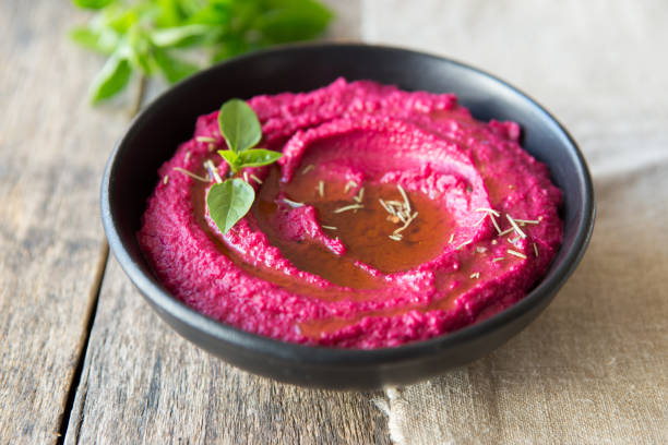 colored hummus, classic hummus, beet hummus, hummus on a dark rustic background. Top view, flat lay. Clean eating, dieting, vegetarian party food.