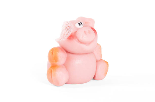 istock Marzipan pig, ready to be eaten, one bite already, isolated on white 1189293727