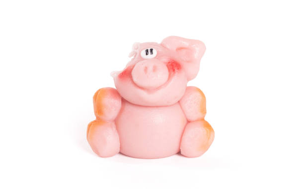 istock Marzipan pig, ready to be eaten, one bite already, isolated on white 1189293746