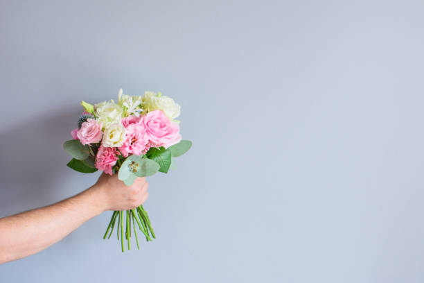 istock Hand with a bouquet of flowers. 1189293889
