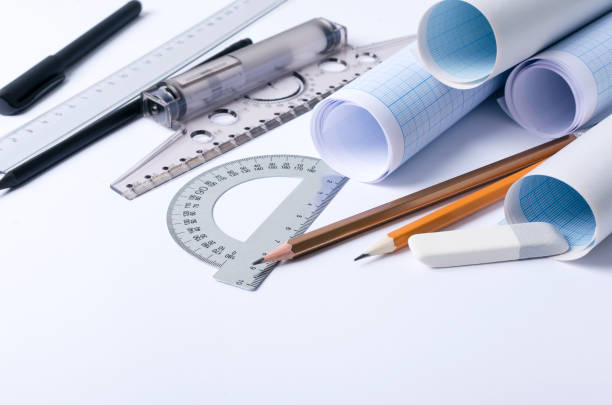 istock T-square, rulers, protractor, pencils, graph paper, documents on the draftsman workplace. Concept of engineer work and special tools 1189294250