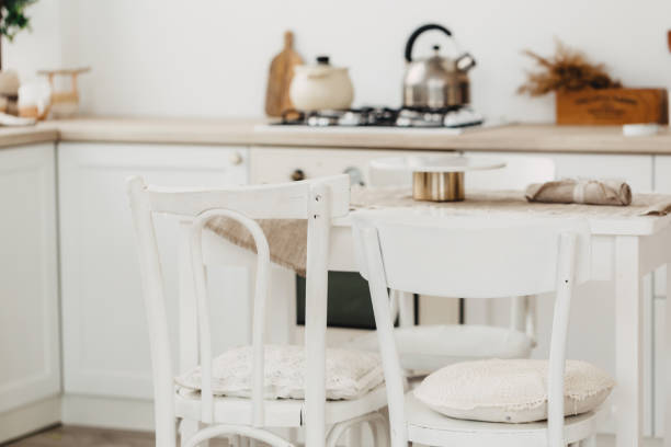 istock Modern new bright kitchen interior with white furniture and a dining table. 1189294902