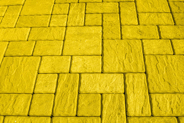 istock Square blocks paving background toned in bright yellow 1189295629