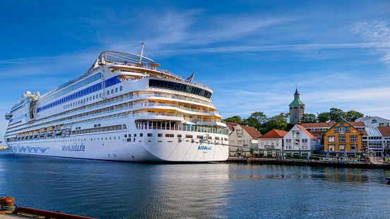 Stavanger, Norway, August 15 - A large cruise ship moored in the bay of Stavanger on the commercial and tourist port. The city of Stavanger, in the south of Norway, is among the favorite tourist destinations of thousands of tourists, especially visiting cruise ships that sail the routes of northern Europe and the Norwegian coast. Image in HD format.