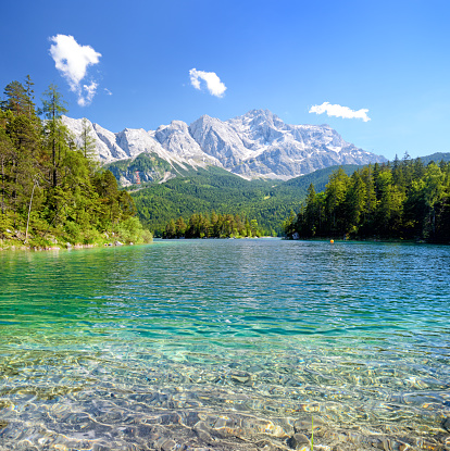 View of the lake Eibsee with the Zugspitze mountain on background, Germany. Composite photo