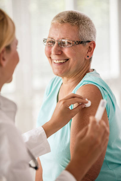 istock Doctor disinfecting patient's arm before vaccination 1189300712