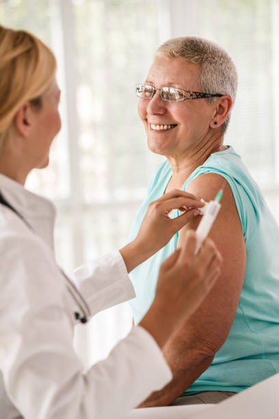 istock Doctor disinfecting patient's arm before vaccination 1189300725