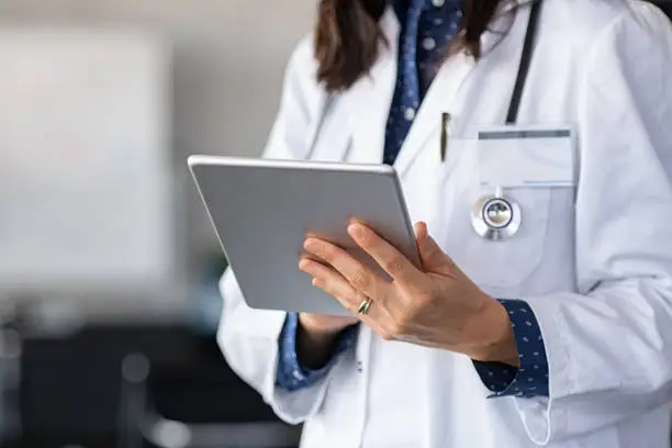 Photo of Doctor using digital tablet