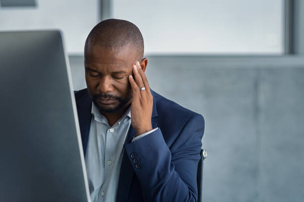 istock Stressed mature businessman working at office 1189303288