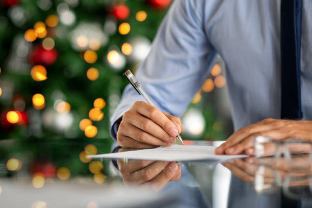 istock Businessman signing document during christmas time 1189303322