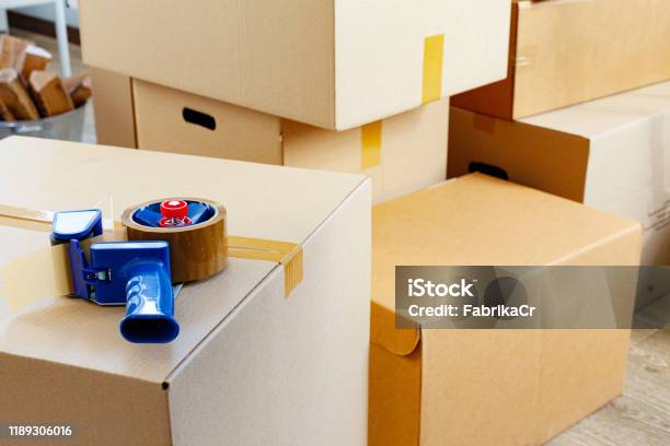 House Moving Concept With Stacked Cardboard Boxes In A Room Stock Photo - Download Image Now
