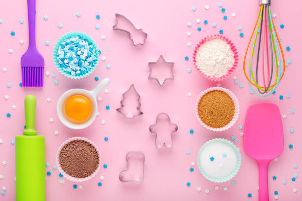 istock ingredients for baking and kitchen tools with cookie cutter on pastel pink background, flat lay 1189307522