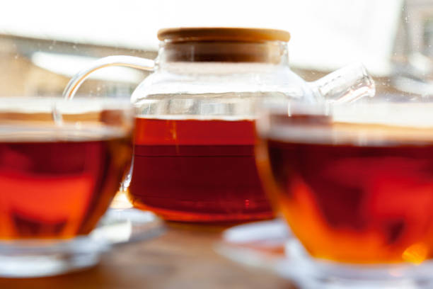 istock Hot cup of tea on wooden rustic table close up 1189308247